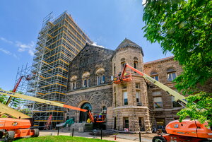 North side of Altgeld Hall. The belltower is surrounded by metal scaffolding. Construction equipment is in the foreground.